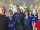 Church leader, police officer and volunteers at St Demetrios Greek Fest in Elmhurst