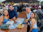 Church leader with guests at the St. Nectarios Greek Fest in Palatine