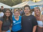 Volunteer with guests at the St. Nectarios Greek Fest in Palatine