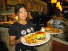 Friendly server with burgers at Xando Cafe in Hickory Hills