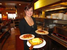 Friendly server with breakfast at Eggville Cafe in Cary