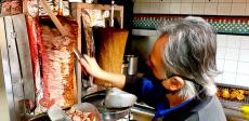 Slicing the famous homemade gyros at Charcoal Flame Grill in Morton Grove