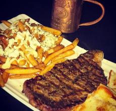 Greek style rib-eye and fries at Jimmy D's District Restaurant in Arlington Heights