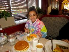 Young guest enjoying breakfast at Omega Restaurant & Pancake House in Downers Grove