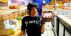 Friendly staff with sweet treat at Papagalino Cafe & Pastry Shop in Niles