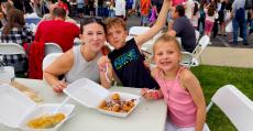 Family enjoying the St. Demetrios Greek Fest in Elmhurst