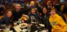 Family enjoying dinner at Woodfire Tavern in Long Grove