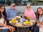 Family enjoying breakfast on the outdoor patio at Maple Butter Cafe in Plainfield