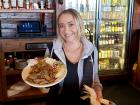 Friendly server with gyros plate at Niko's Tavern in Elgin
