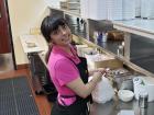 Friendly server with carryout order at Tasty Waffle Restaurant in Plainfield