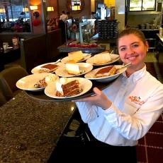 Friendly server with desserts at Blossom Cafe in Norridge
