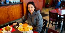 Loyal customer enjoying lunch at Brandy's Gyros in Chicago