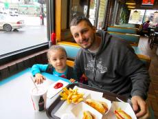 Father and daughter enjoying the famous hot dogs at Franksville Restaurant in Chicago