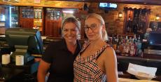 Bar server with customer at Johnny's Kitchen & Tap in Glenview