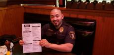 Police officer enjoying lunch at Johnny's Kitchen & Tap in Glenview