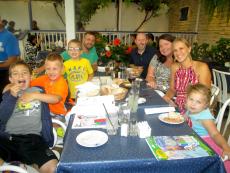 Family enjoying dinner in the outdoor terrace at Mykonos Greek Restaurant in Niles