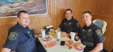 Police officers enjoying lunch at Nick's Drive In Restaurant Chicago