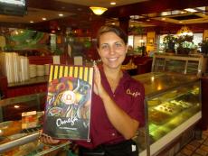 Friendly server with menus at Omega Restaurant & Pancake House in Downers Grove