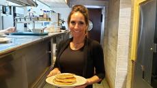 Friendly server with pancakes at Seven Dwarfs Restaurant in Wheaton